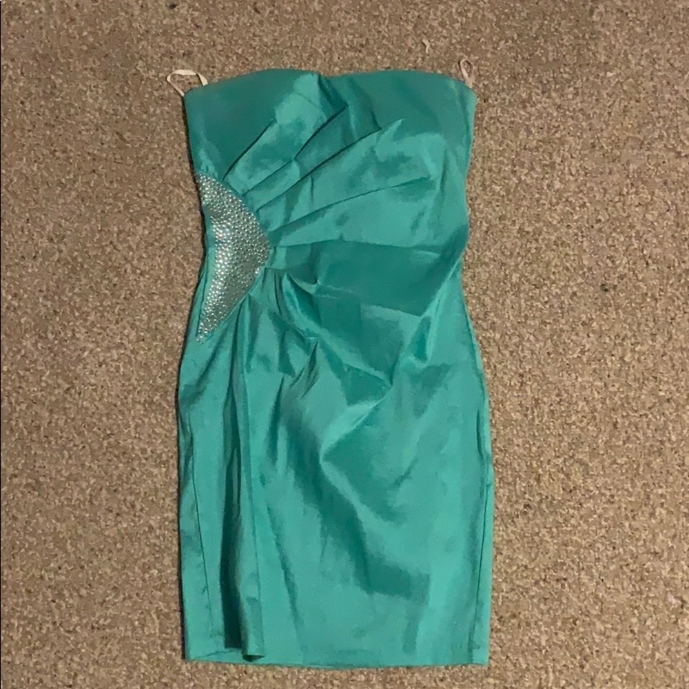 Light blue/green colored dress.